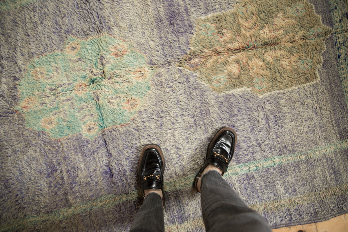Vintage Moroccan rug's high-low pile texture, showing unique contoured medallion in purple, mint, and blush.