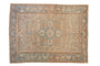 Vintage distressed Ahar rug with cream, sky blue, and red floral medallion and vines.