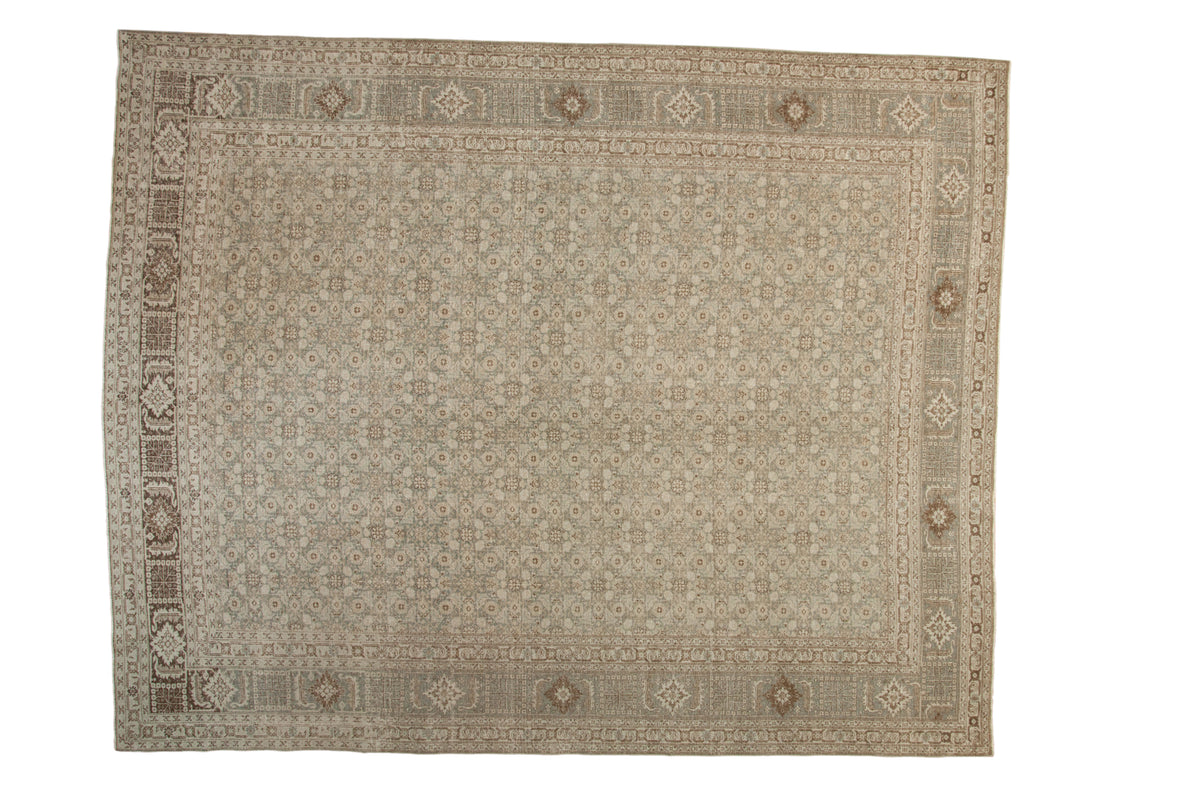 Distressed vintage Tabriz carpet with faded Herati motif, platinum and oxidized silver tones.