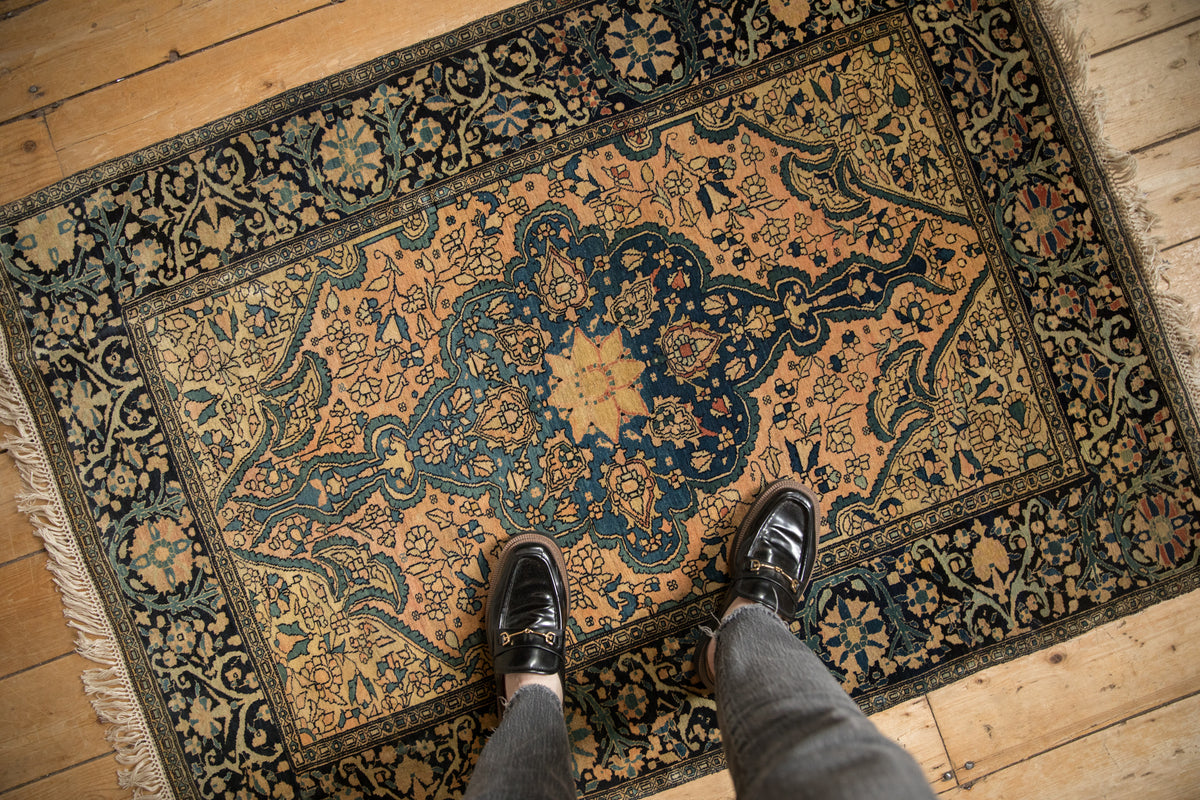 Antique Farahan Sarouk rug showcasing roundel medallion, oversized finials, and muted floral field.