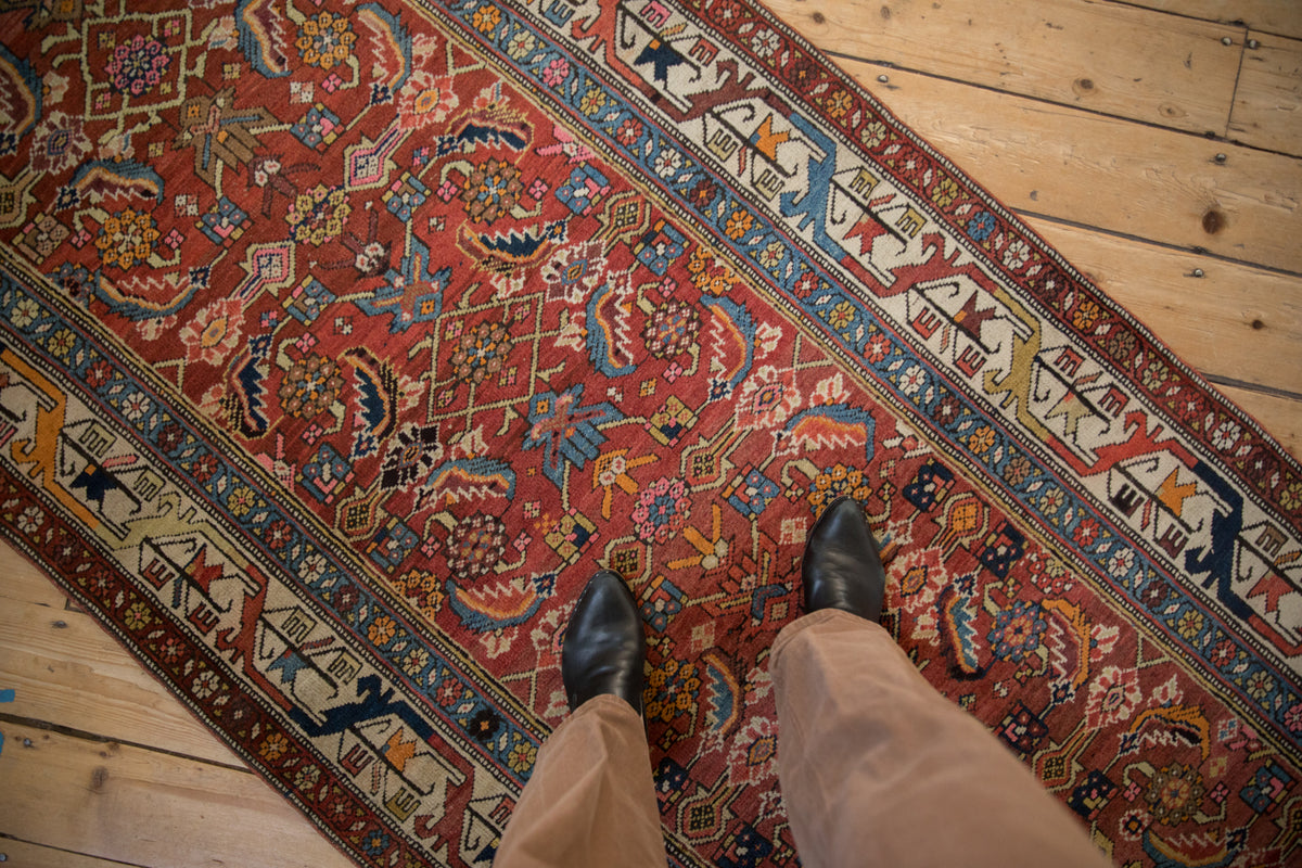 Antique Persian Bijar rug detail showing colorful Herati motif with serrated leaves and vine border.