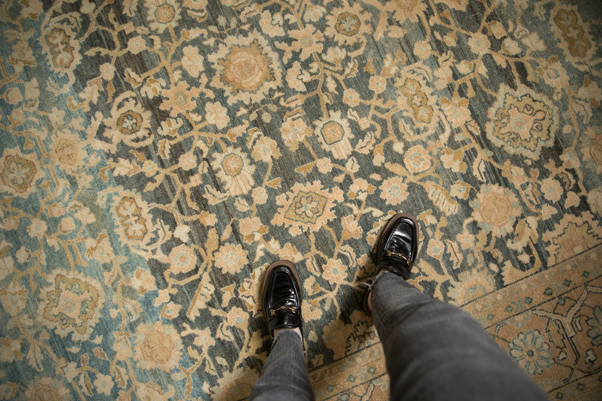 Vintage Lilihan carpet detail showcasing muted blue, charcoal, beige allover floral pattern and softened texture.