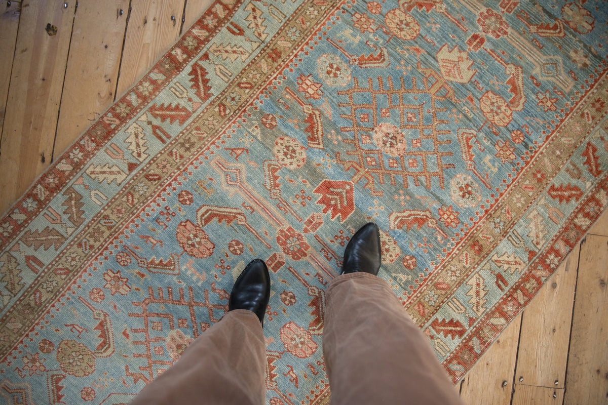 Distressed Northwest Persian runner's abrash sky blue field with Herati motifs and soft red accents.