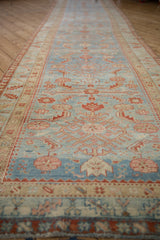 Distressed vintage Persian runner with Herati and pawn design motifs, featuring blue abrash and faded red.