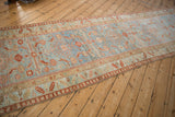 Distressed Northwest Persian runner's serrated leaf border and faded Herati field motif.