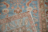 Distressed vintage Persian runner close-up: blue field with Herati-pawn motifs and woven reverse.