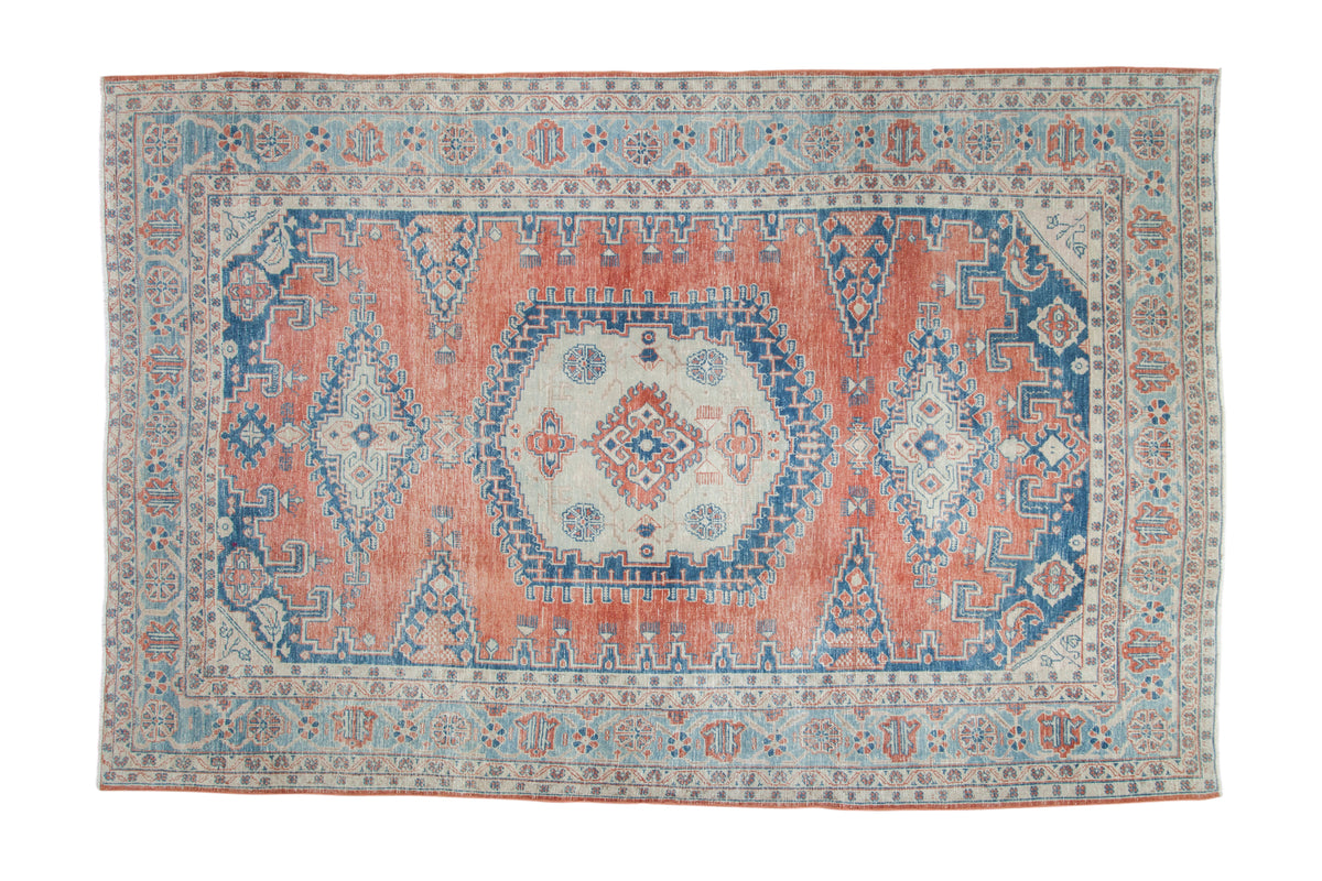 Distressed vintage Veece carpet, faded melon red and dusty sapphire blue geometric medallion, 6'11" x 10'5".