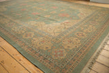 Hand-woven Soumac carpet corner with seafoam green and pale gold Serapi-inspired patterns.