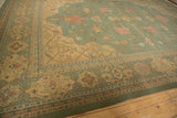 Indian Soumac carpet corner with a Serapi-inspired gold border and seafoam green floral field.