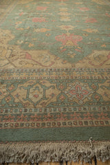 Low angled view of a tea-washed Soumac rug's detailed border and thick ivory fringe.