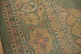 Close-up of the Serapi-inspired geometric border in seafoam green, pale gold, and terracotta.