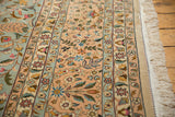 Side view of the vintage carpet's floral border, intact selvage, and clean ivory fringe.