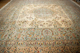 Low angle view of the vintage Kerman carpet's ornate floral details in powder blue and ivory.