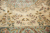 Rococo scrolling and floral sprays on the plush ivory and powder blue pile of a vintage carpet.