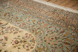 Rococo-style floral sprays on the powder blue, sand, and ivory fields of the vintage carpet.