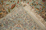 Folded corner of a vintage Kerman carpet showing the woven back, selvage, and hand-knotted pile.