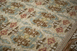 Embossed Arts and Crafts floral pattern with 3D contour in beige, blue, and raspberry.