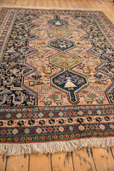 Vintage Ardebil carpet's hand-knotted fringe and geometric border in navy blue, peach, and ivory.