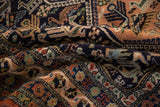 Plush navy pile of the vintage Ardebil rug, with intricate peach, ivory, and powder blue motifs.