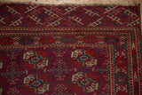 Corner detail of a vintage Tekke rug showing intricate geometric borders and gul motifs.