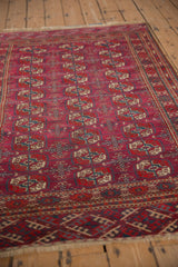 A perspective view of the repeating gul motifs on a vintage Turkmen Tekke rug.