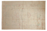 Distressed vintage Bulgarian Polonaise carpet with a faded medallion in soft ivory, raspberry, and powder blue.