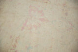 Detail of the rug's back, showing the hand-knotted construction and ivory foundation.