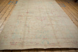 A low angle on the vintage distressed carpet shows its even short pile and subtle pattern.
