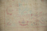 Even short pile texture of a distressed rug with pale raspberry and powder blue hues.