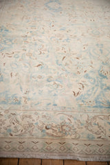 Evenly worn, low pile texture on a vintage Polonaise carpet in ivory and powder blue.