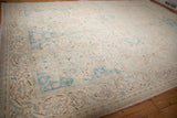 Angled perspective of the oversized Bulgarian carpet, showing its softly worn floral pattern and texture.
