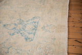 Detailed view of the tattered original side cord and mostly even wear on the vintage rug.