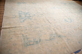 Distressed low pile on a vintage Bulgarian carpet showing muted powder blue and ivory.