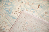 Folded corner of a vintage Polonaise carpet reveals its hand-woven back and original mauve selvage.