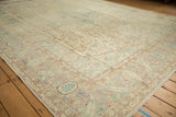 Distressed Bijar rug corner, pale blue and dusty rose Herati motifs, elongated boteh border.