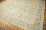 Distressed Bulgarian Bijar rug showing abrash ivory, pale pink, and seafoam blue motifs.