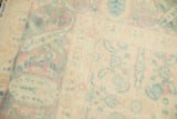 Detail of vintage rug with low pile, showing muted raspberry and seafoam abrashes.