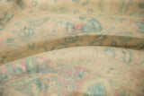 Low shorn pile and heavy abrashes on distressed vintage rug in muted tones.