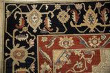 Armenian Serapi design rug corner, intricate vine and floral patterns on navy field and madder red border.