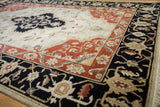 Vintage Armenian Serapi rug's corner with dark navy and terra cotta floral vine borders.