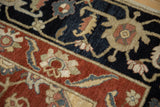 Deep navy, madder red, and beige floral palmettes on vintage Armenian Serapi rug pile.