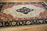 Vintage Armenian Serapi rug with elaborate navy border and terra cotta floral corner spandrel.