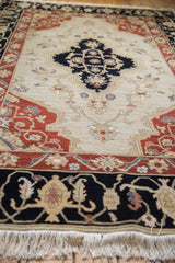Original full cream fringe with dark navy border and madder red floral motifs.