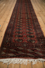 Angled perspective of a long Bokhara runner with repeating gul medallions.