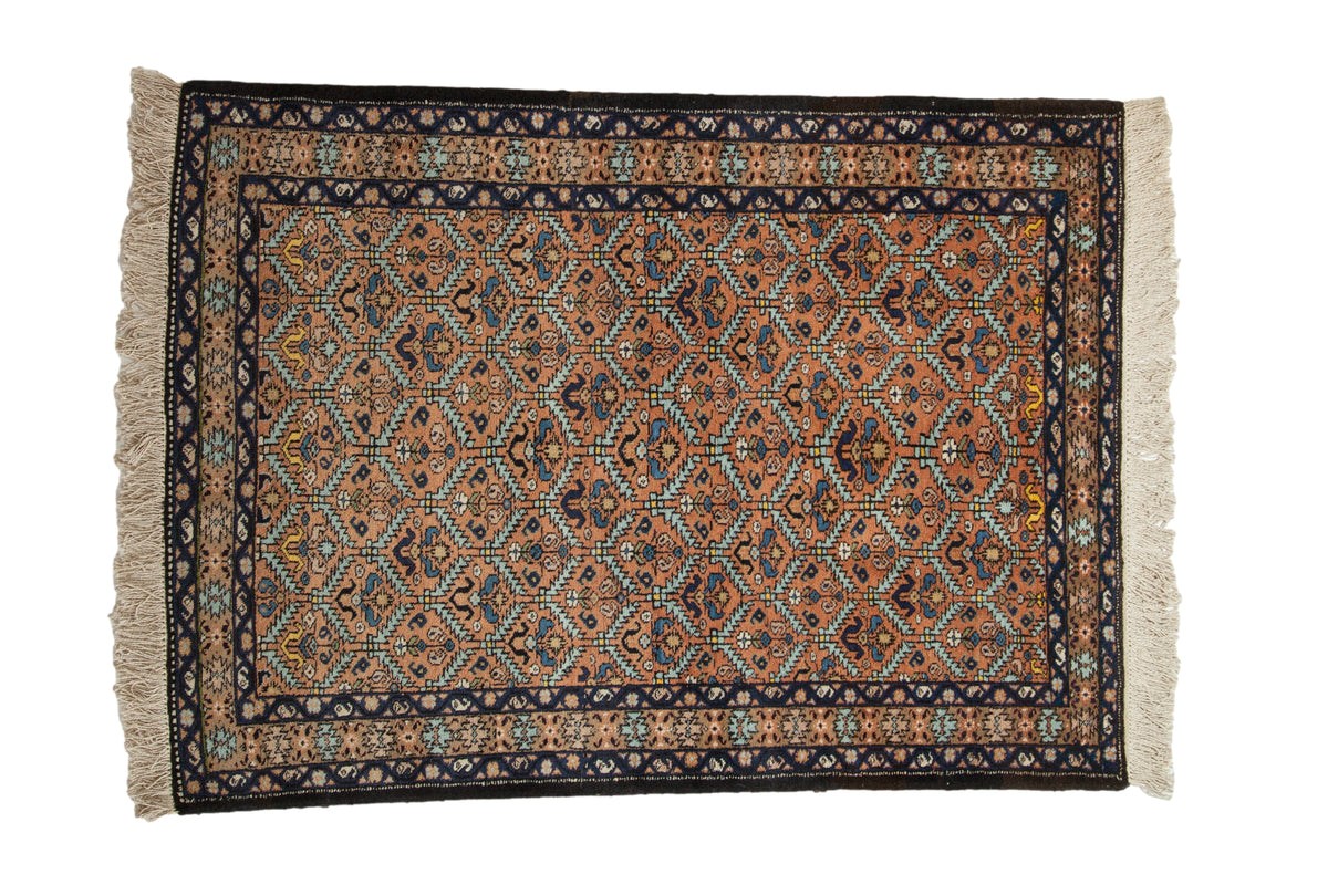 Vintage Ardebil rug with a rust lattice field featuring botehs and floral motifs in navy, sky blue, and yellow.