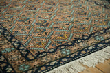 Full pile and serrated leaf lattice pattern on the corner of a vintage Ardebil rug.