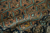 Folded vintage Ardebil rug highlighting its full pile and serrated leaf lattice design.