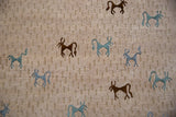 Indian Folk Art rug's textured beige pile, with primitive teal and brown art silk animals.