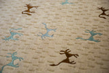 Stylized teal and dark brown art silk animals on a textured beige folk art carpet.