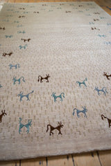 Subtle tone-on-tone beige field texture with teal and dark brown art silk animals.